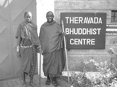 Beside a Maasai elder at the centre &mdash; his brown robes were often mistaken for Maasai dress.