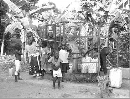 Children at the centre&rsquo;s well &mdash; clean water for a village that had had almost none.
